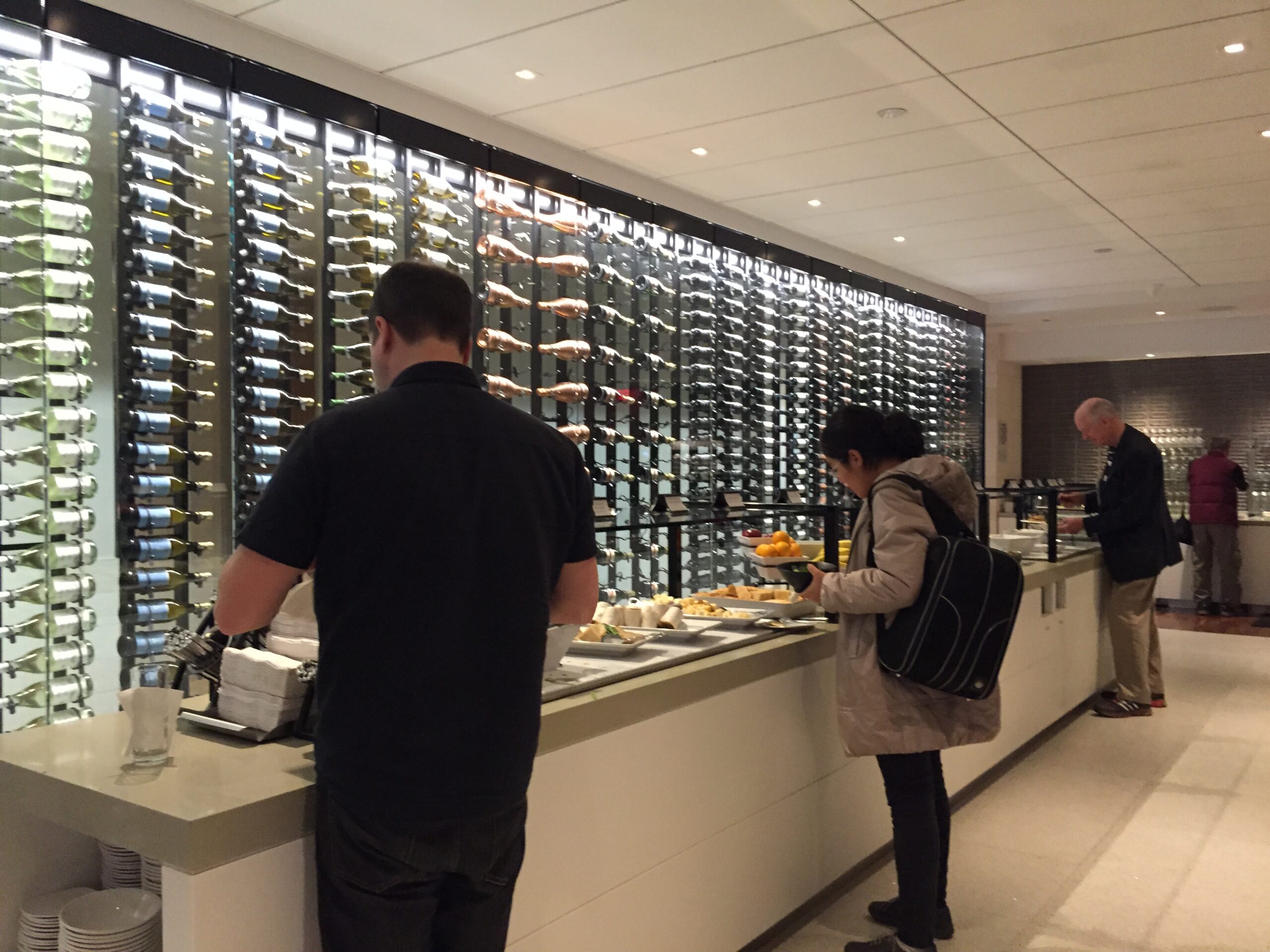 people standing in front of a wall of food