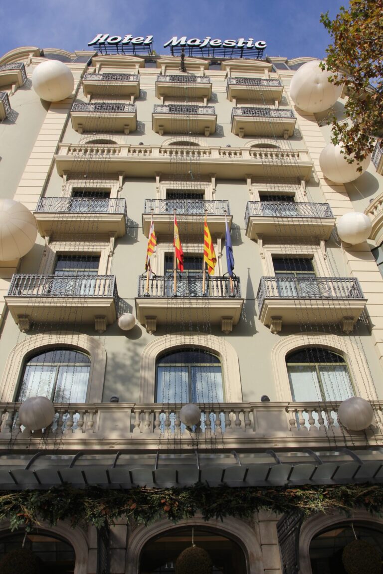 a building with flags on the balcony