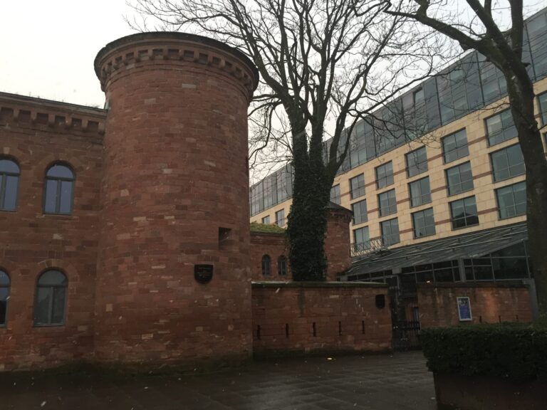 a brick building with a tree in front of it