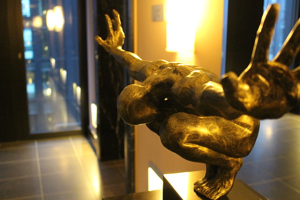 a statue of a person with a hand extended
