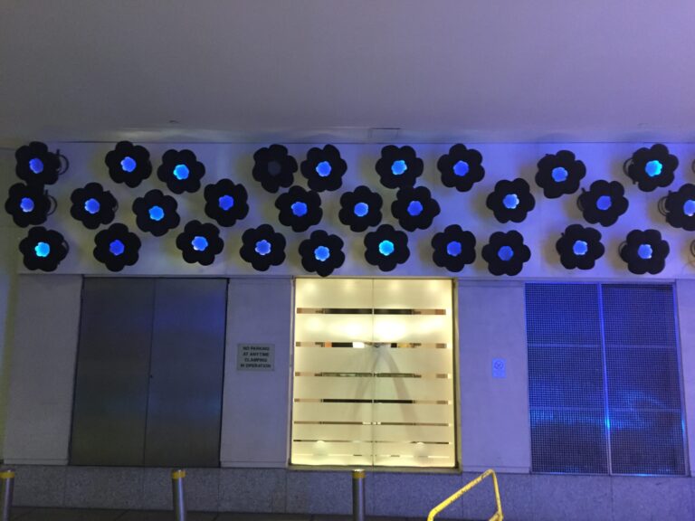 a wall with flowers and lights