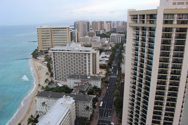 a city with many tall buildings and a beach