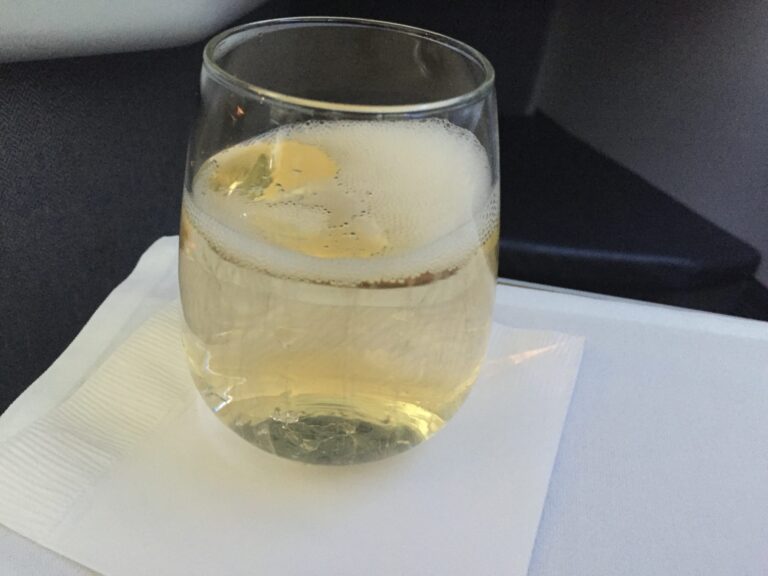 a glass of liquid on a napkin