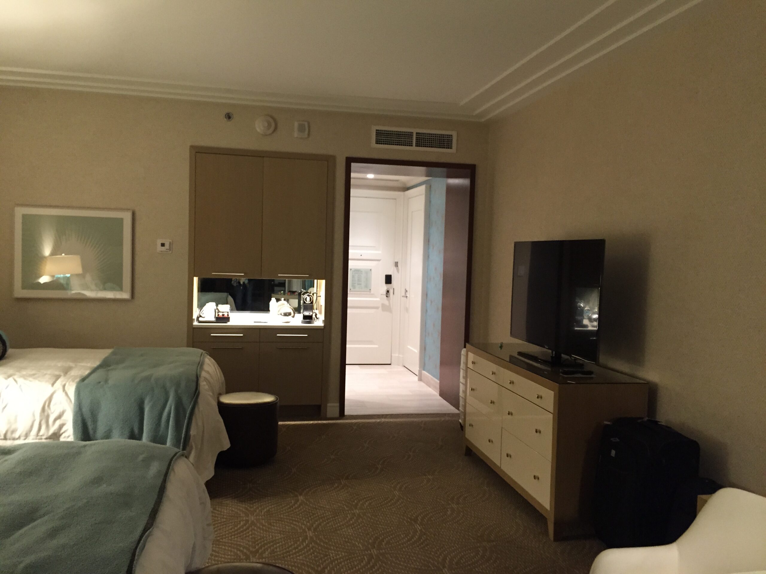 a room with two beds and a tv