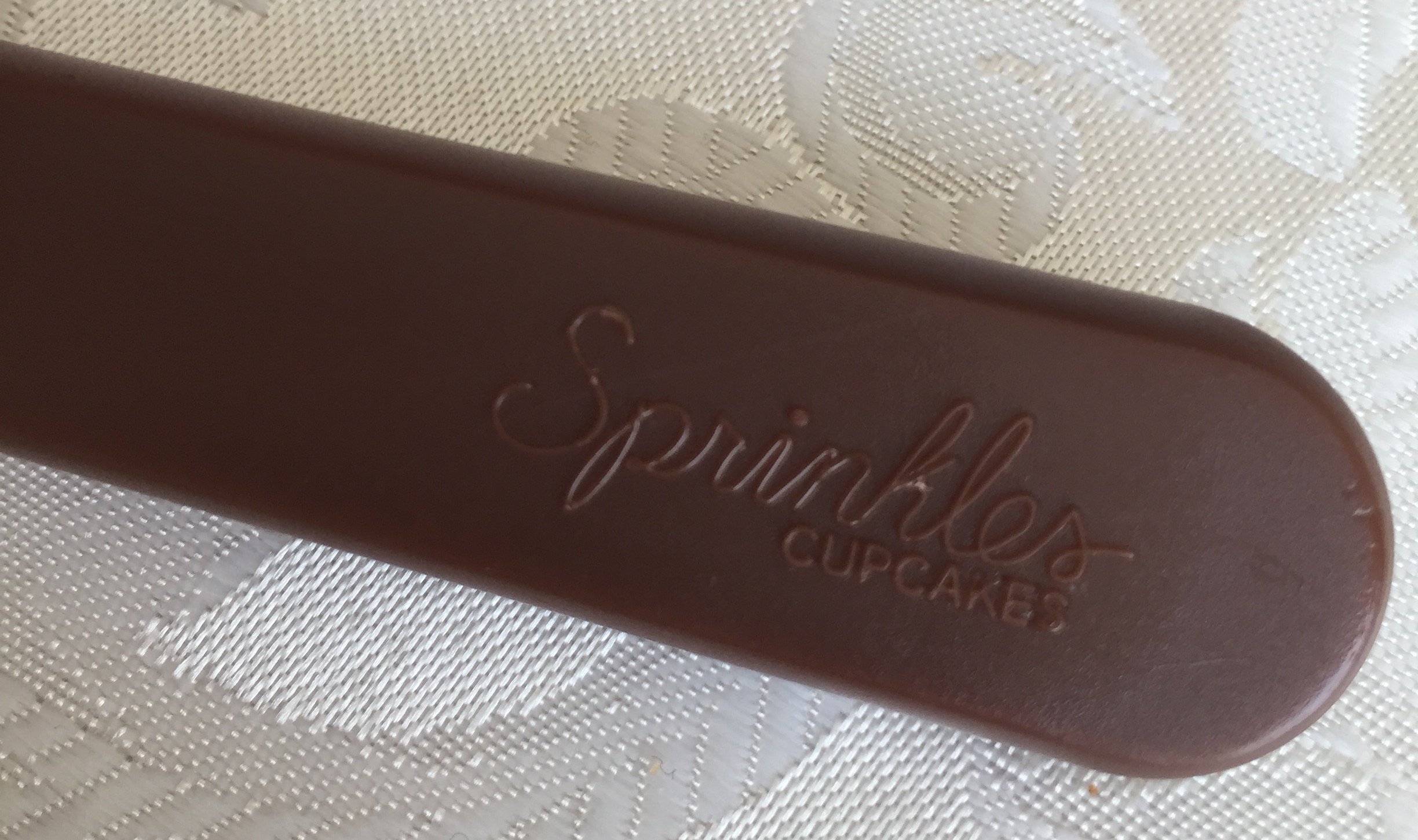 a brown rectangular object with text on it