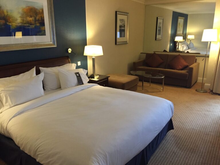 a hotel room with a bed and couches