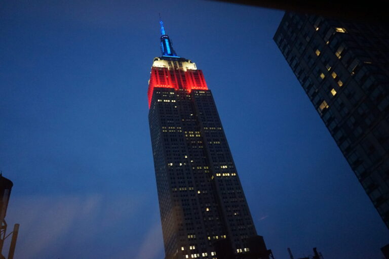a tall building with a red and blue light