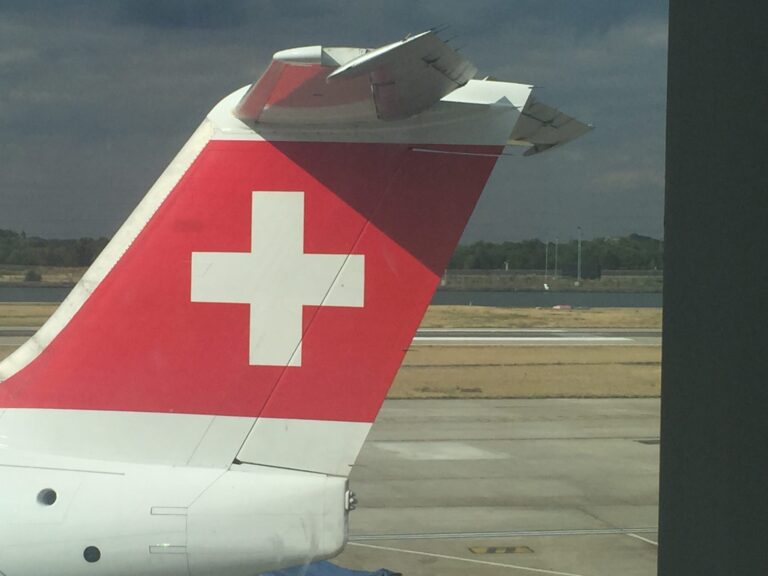 the tail of an airplane with a white cross on it