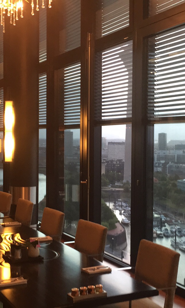 a room with a table and chairs and a view of a city