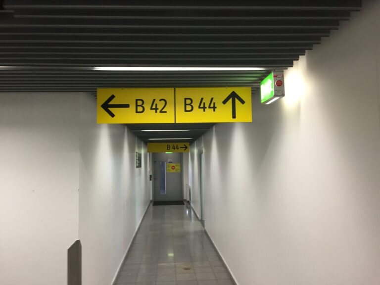 a hallway with signs and arrows