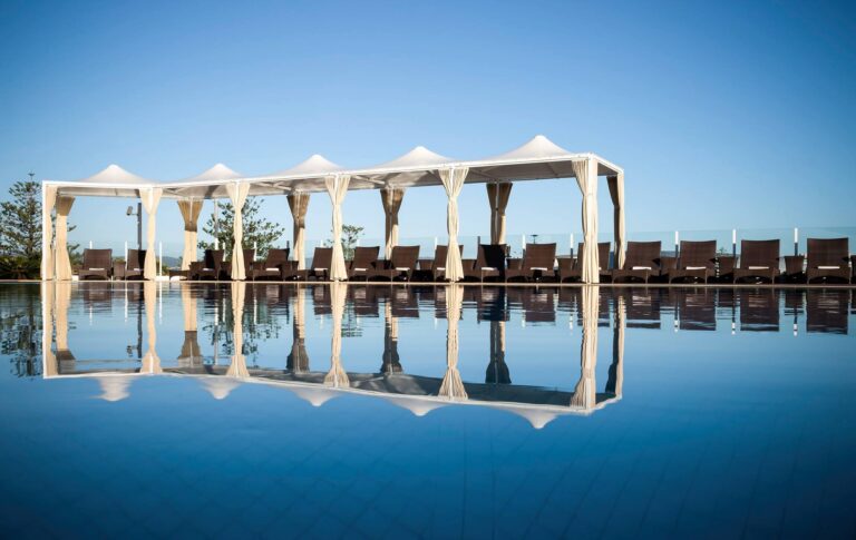 a pool with a white canopy over it