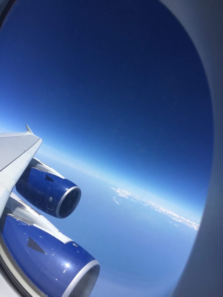 an airplane wing with blue and white engines