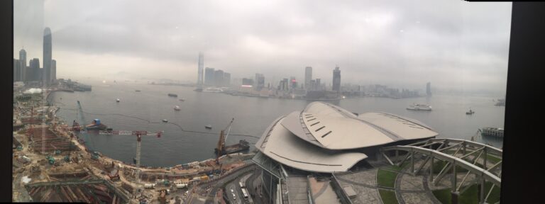 a city skyline with a body of water and a large building
