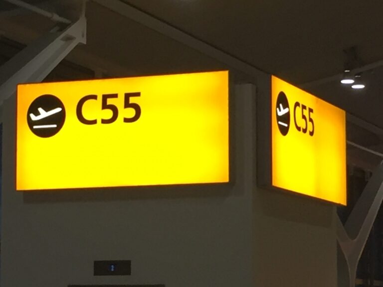a yellow sign with black text and arrows
