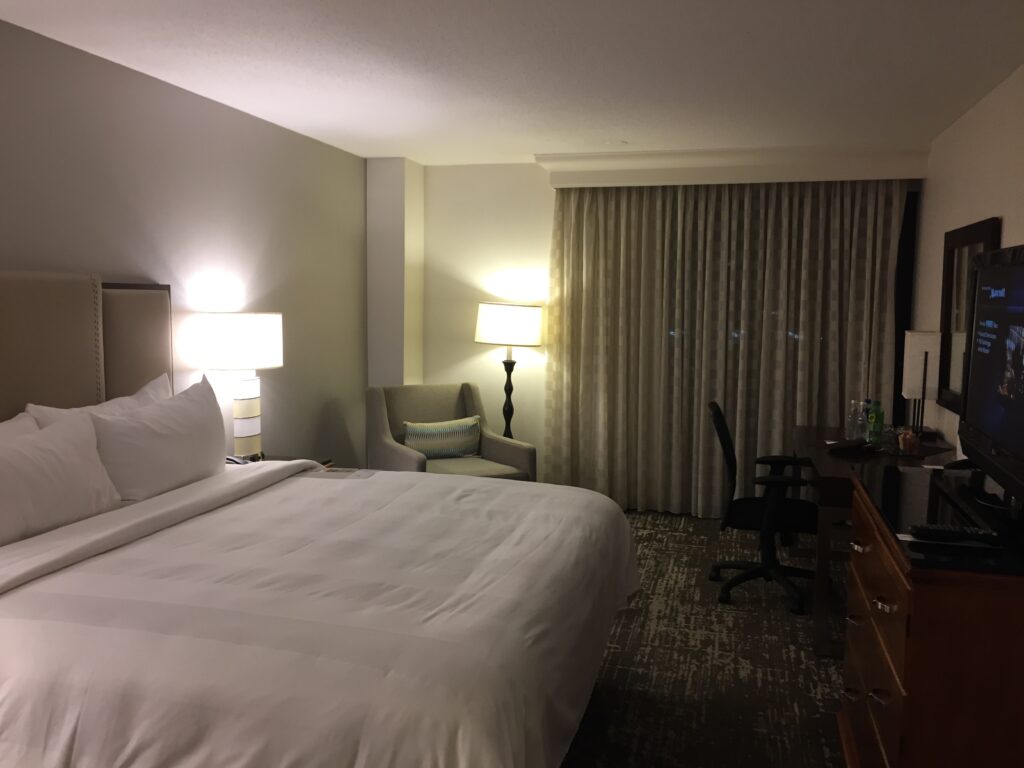 a hotel room with a bed and a chair