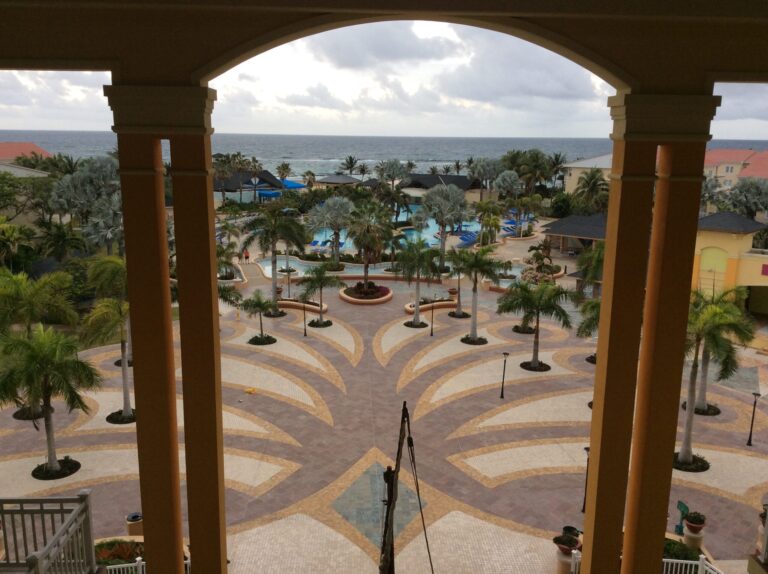 a view of a pool and a beach from a balcony