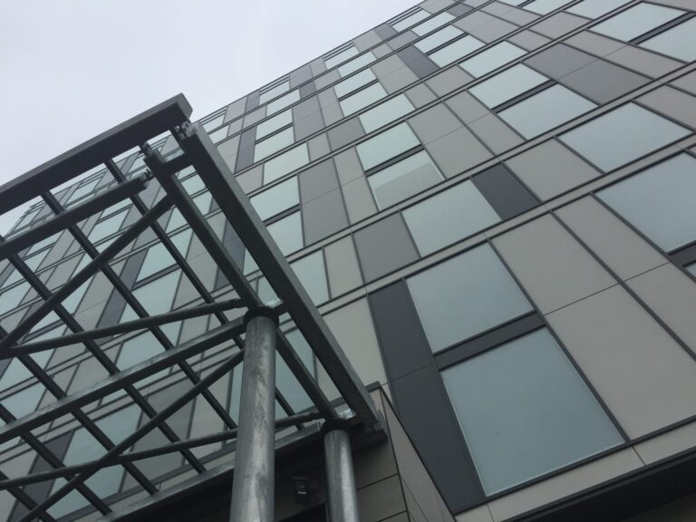a metal railing next to a building