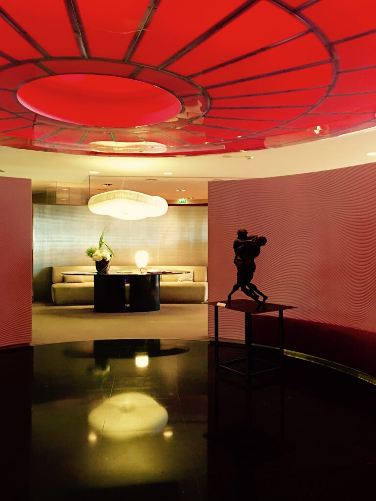 a room with a red ceiling and a statue