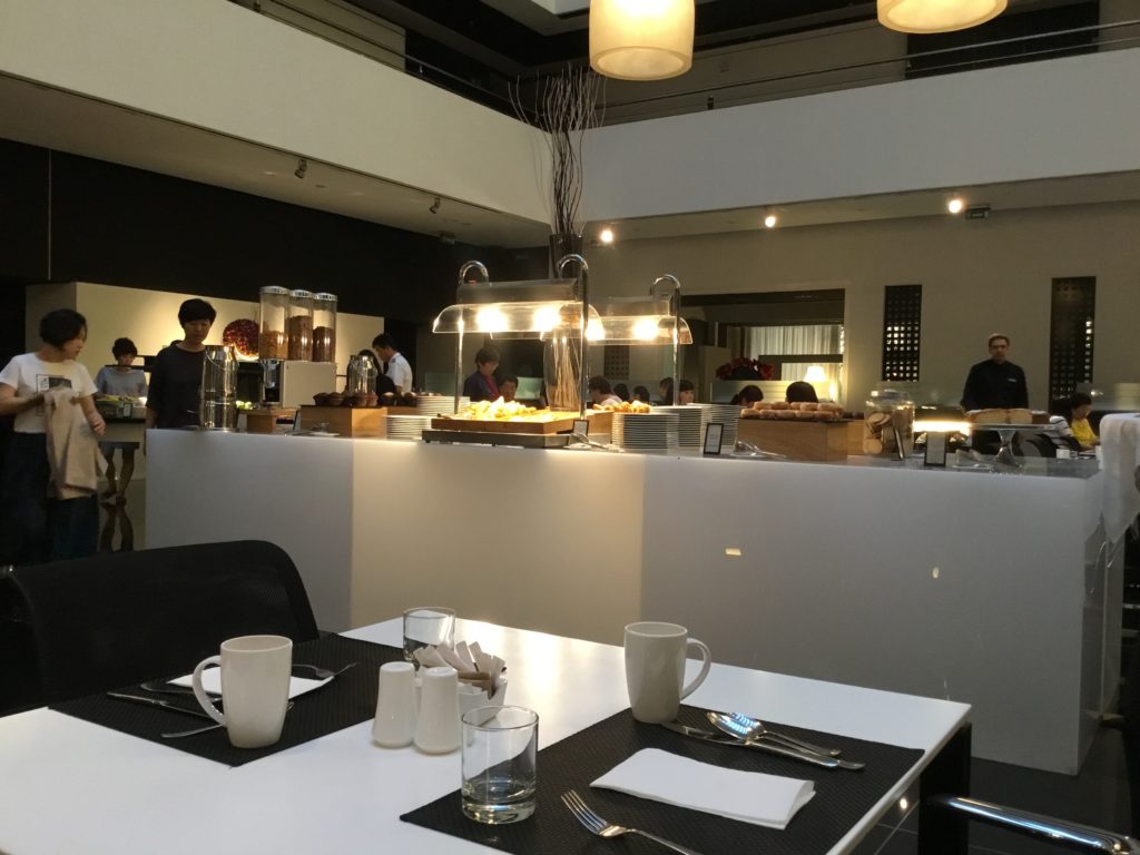 a restaurant with a counter and people in the background