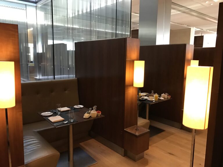 a restaurant booth with tables and lamps