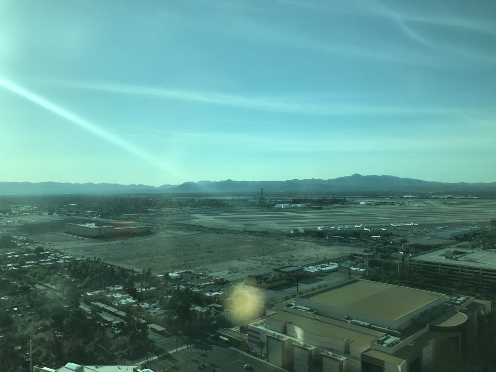 a city with buildings and mountains in the background