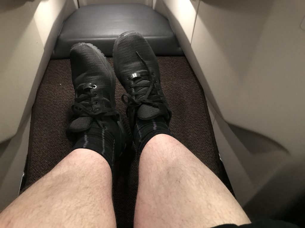 a person's legs in black shoes