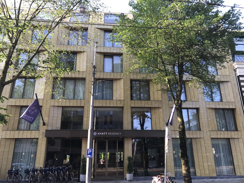 a building with trees and a bike rack