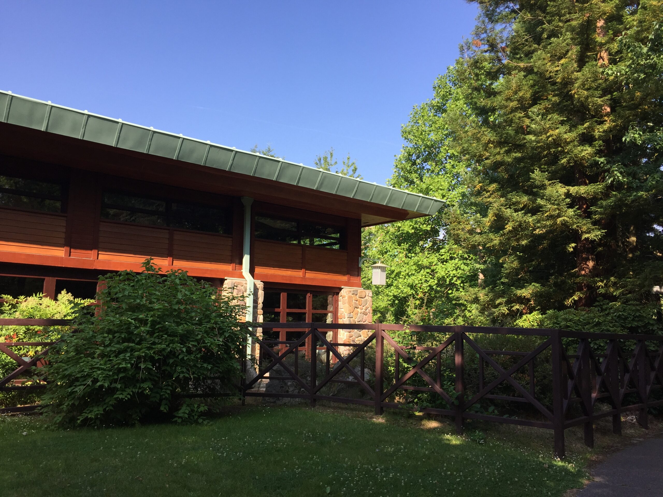 a house with a fence and trees