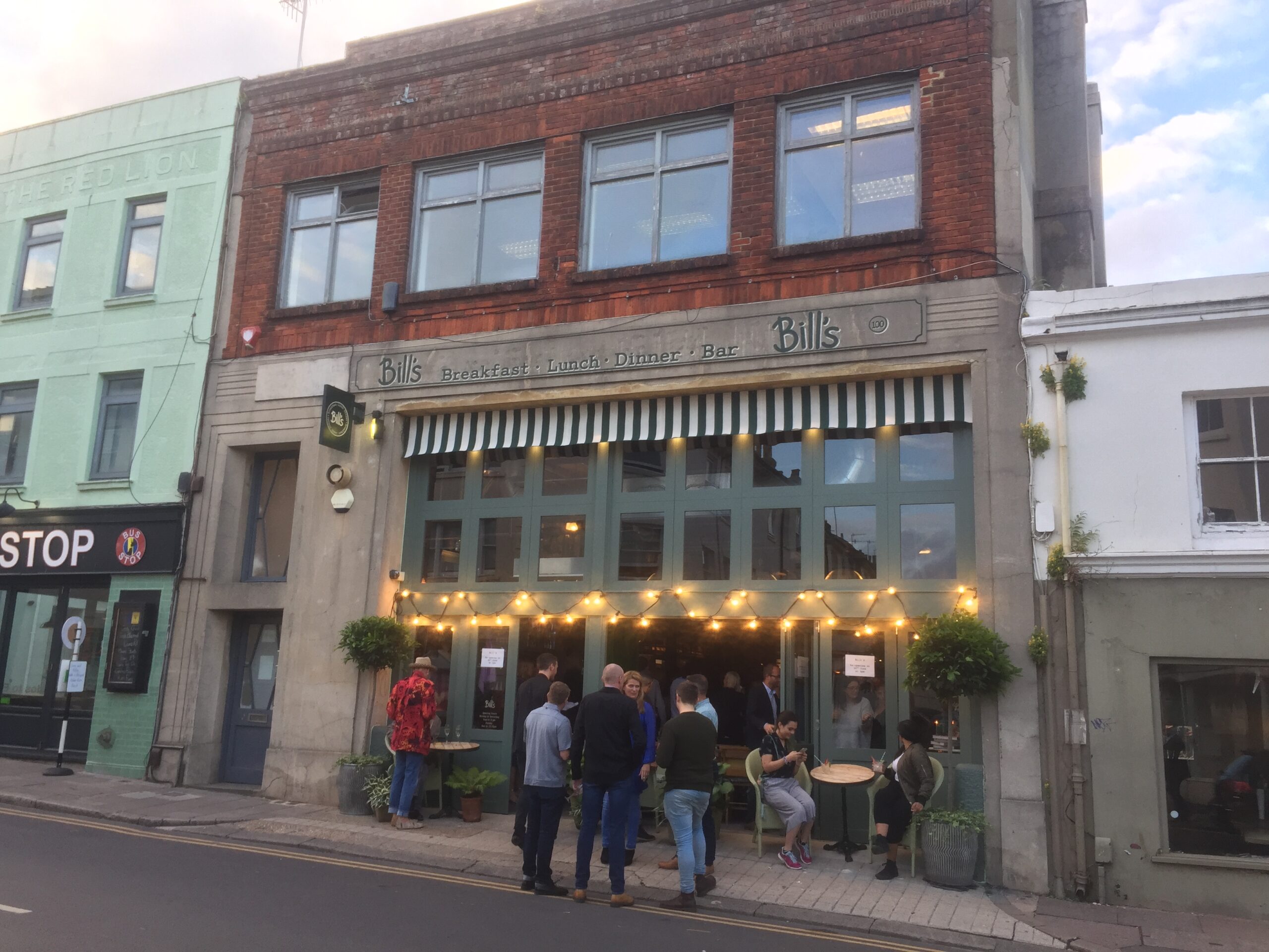 a group of people outside a restaurant