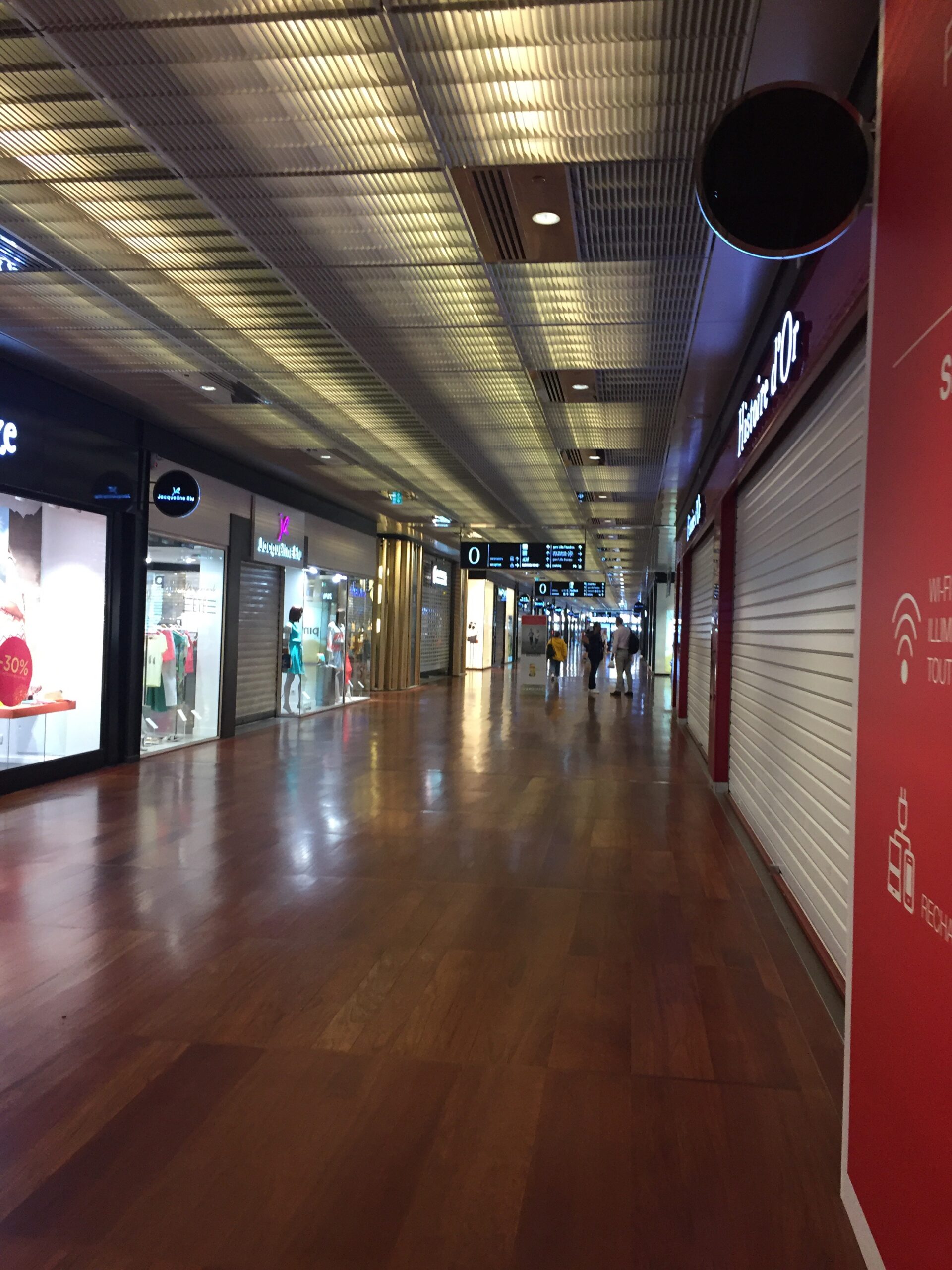 a hallway with storefronts and signs