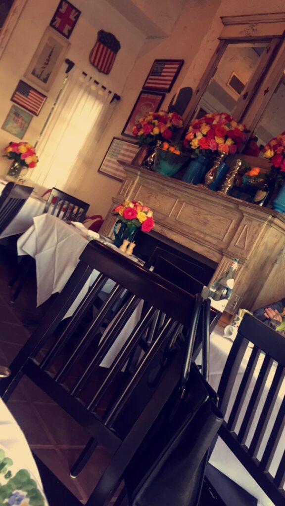 a room with a fireplace and flowers
