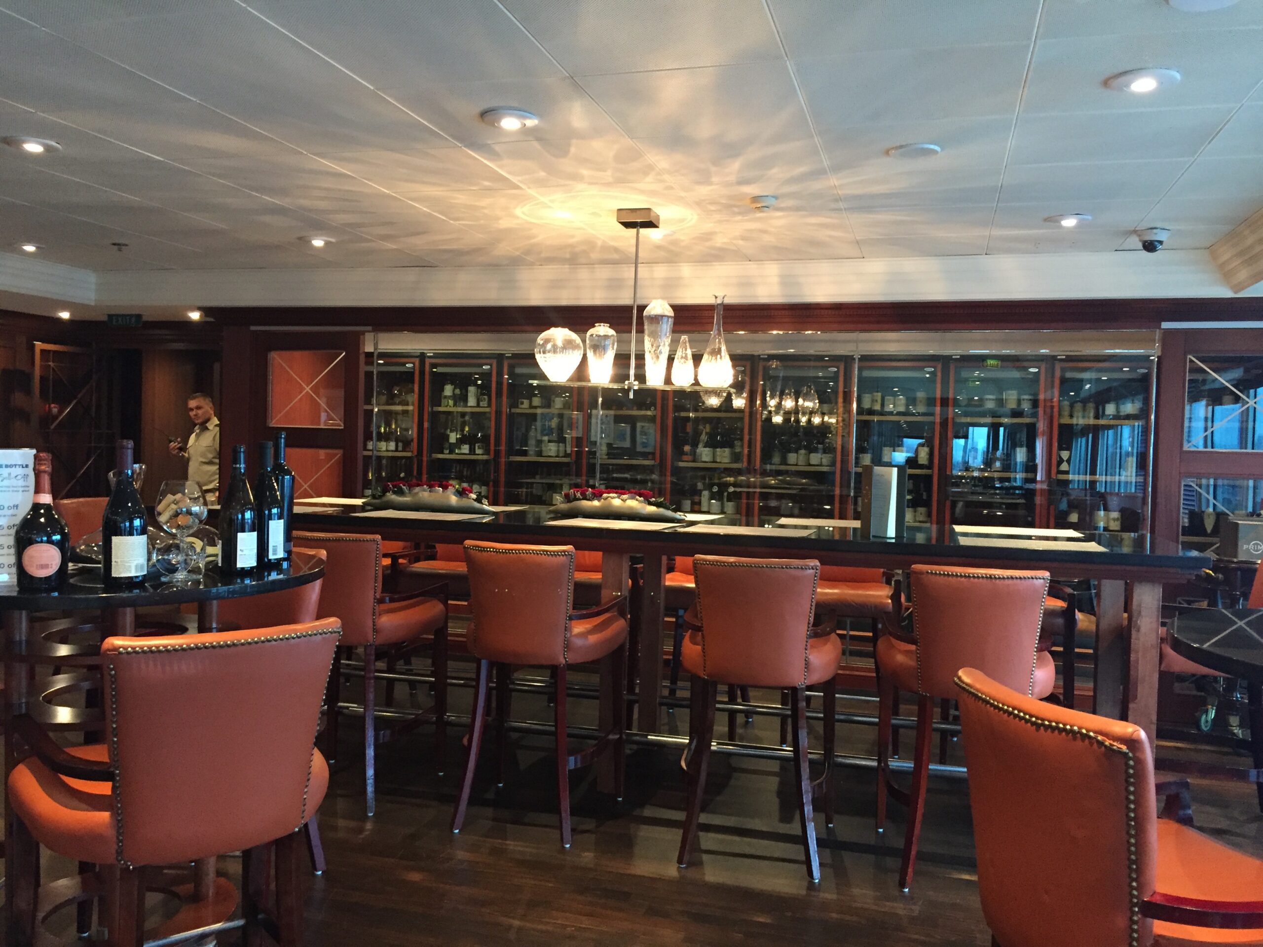 a room with a bar and chairs