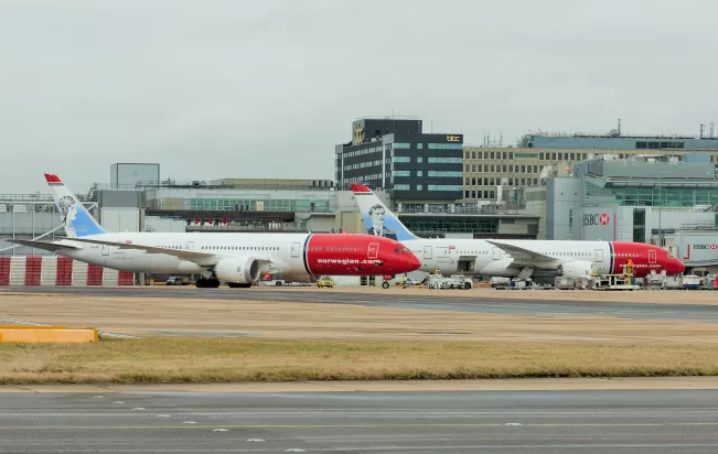 a group of airplanes on a runway