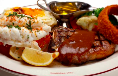 a plate of food with a sauce and lemon