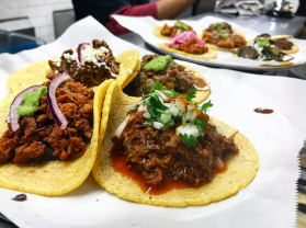 a plate of tacos with meat and vegetables