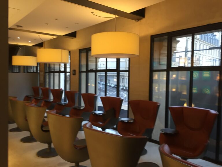 a room with chairs and lamps