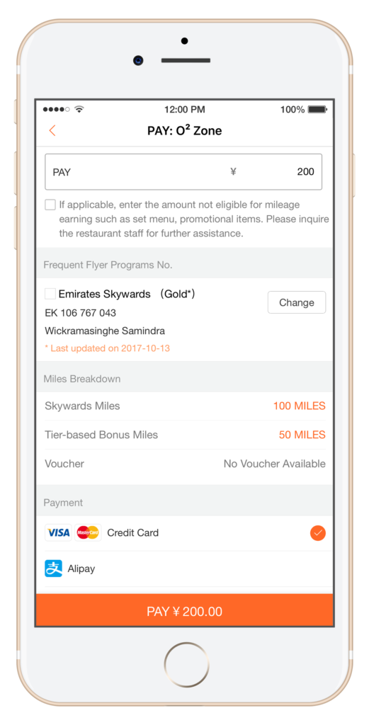 The image shows a smartphone screen displaying a payment interface for "O² Zone." The interface includes the following details:
- A field labeled "PAY" with an amount of ¥200.
- A checkbox with a note about entering amounts not eligible for mileage earning.
- A section for "Frequent Flyer Programs No." with an option for "Emirates Skywards (Gold*)" selected, showing a membership number and a name.
- A "Miles Breakdown" section indicating "Skywards Miles: 100 MILES" and "Tier-based Bonus Miles: 50 MILES."
- A "Voucher" section stating "No Voucher Available."
- A "Payment" section with options for "Credit Card" (selected) and "Alipay."
- A large orange button at the bottom labeled "PAY ¥200.00."
The top of the screen shows the time (12:00 PM), battery status (100%), and signal strength.
