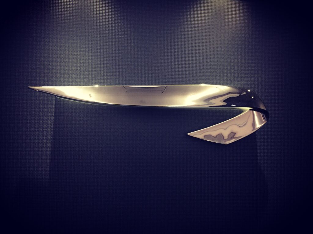 a silver object on a black surface