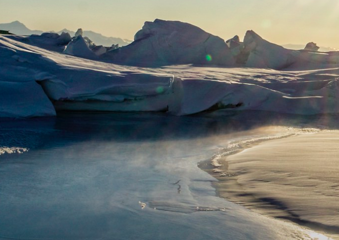 a snowy beach with icebergs and snow