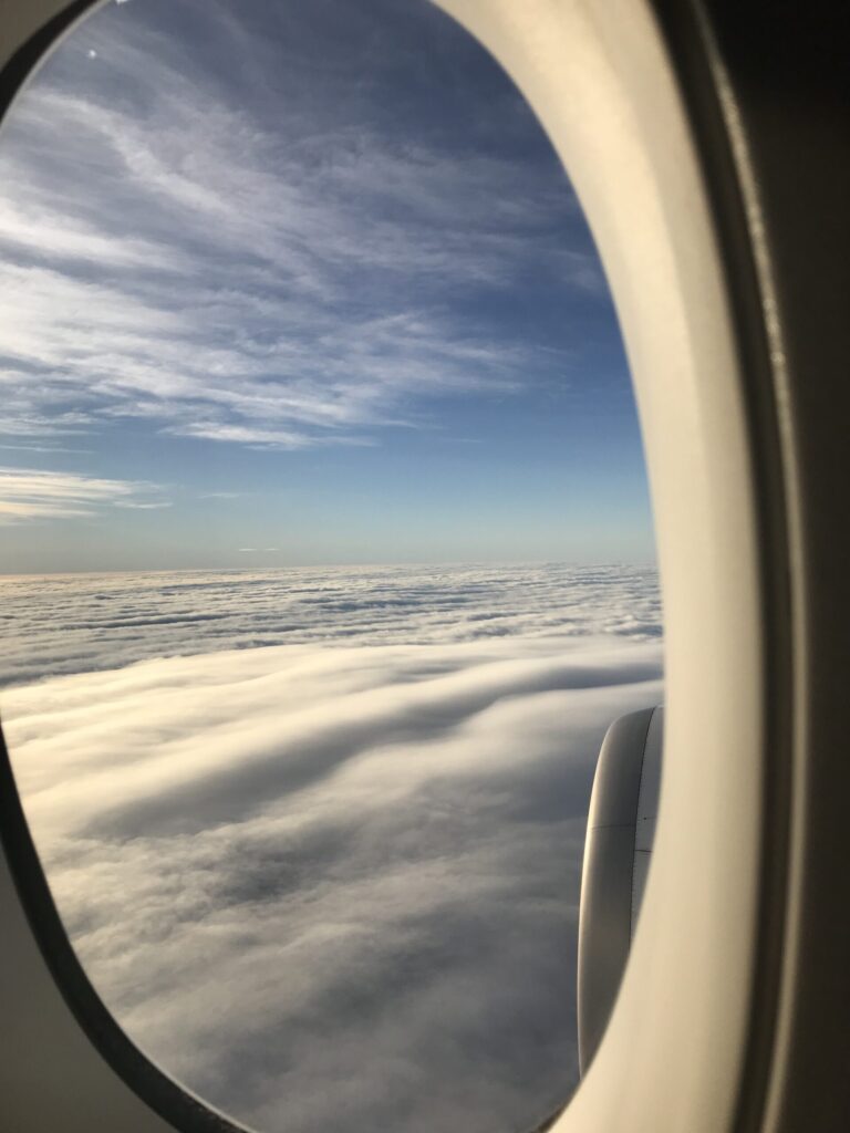 view of clouds and sky from an airplane window