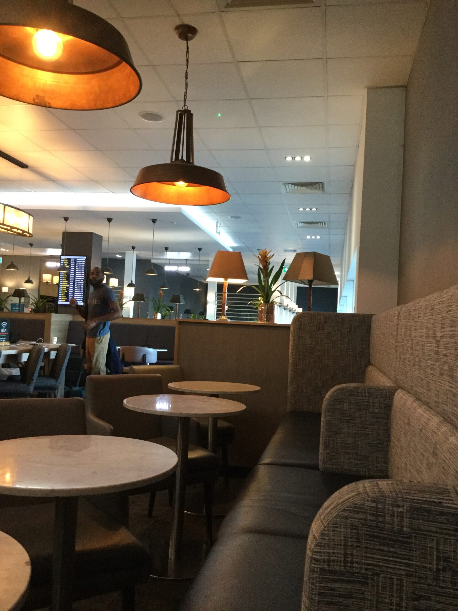 a room with a couch and tables and chairs