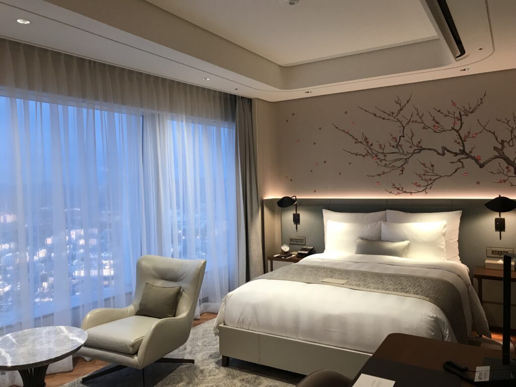 a bedroom with a bed and a chair