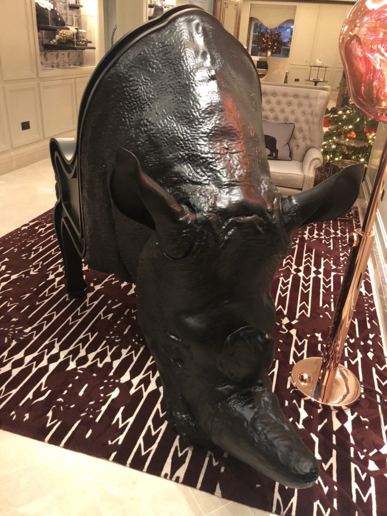 a rhinoceros head on a chair