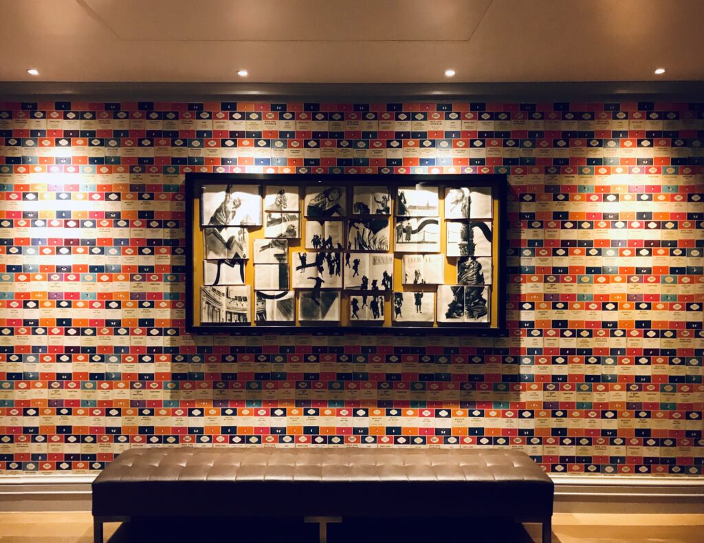 a wall with a bench and a picture of a man