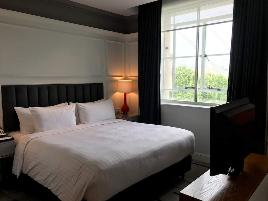 a bed with a lamp in a room