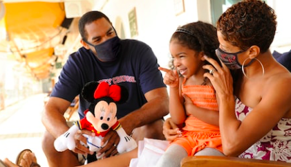 a man and a girl with a toy mouse
