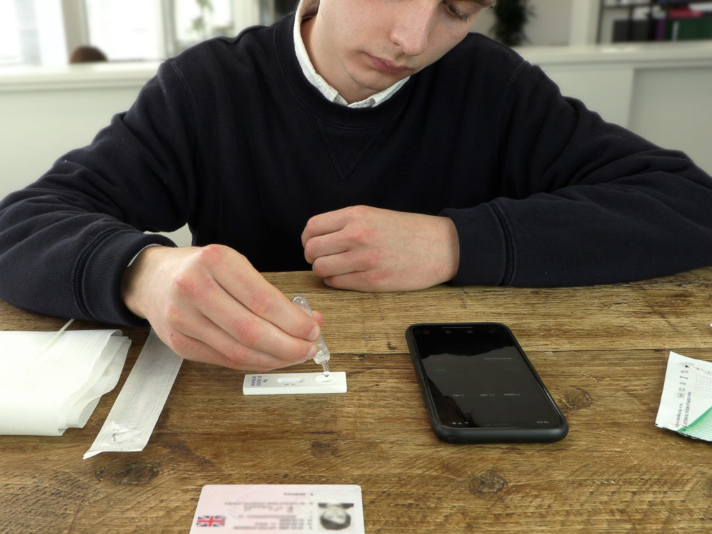 a man sitting at a table with a pipette