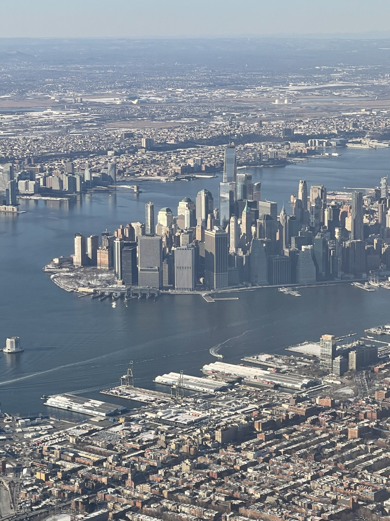 a city with many tall buildings and a body of water