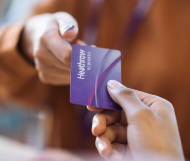 a person handing over a card to another person